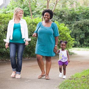mom, child and mother to be walking