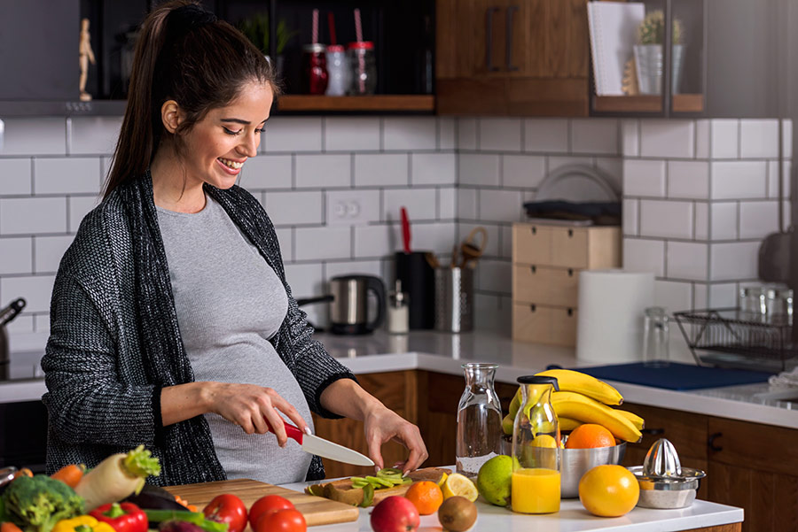 pregnant woman prepping meal