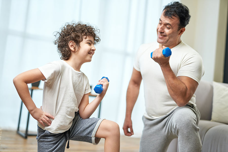 dad and son with dumbbells